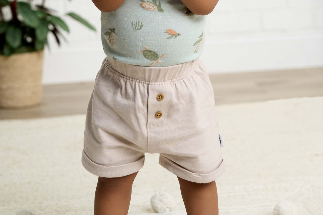 A closeup of baby shorts in a tan color.
