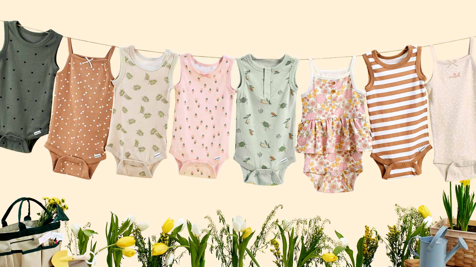 Boy and girl tank style onesie bodysuits hanging from a clothesline.