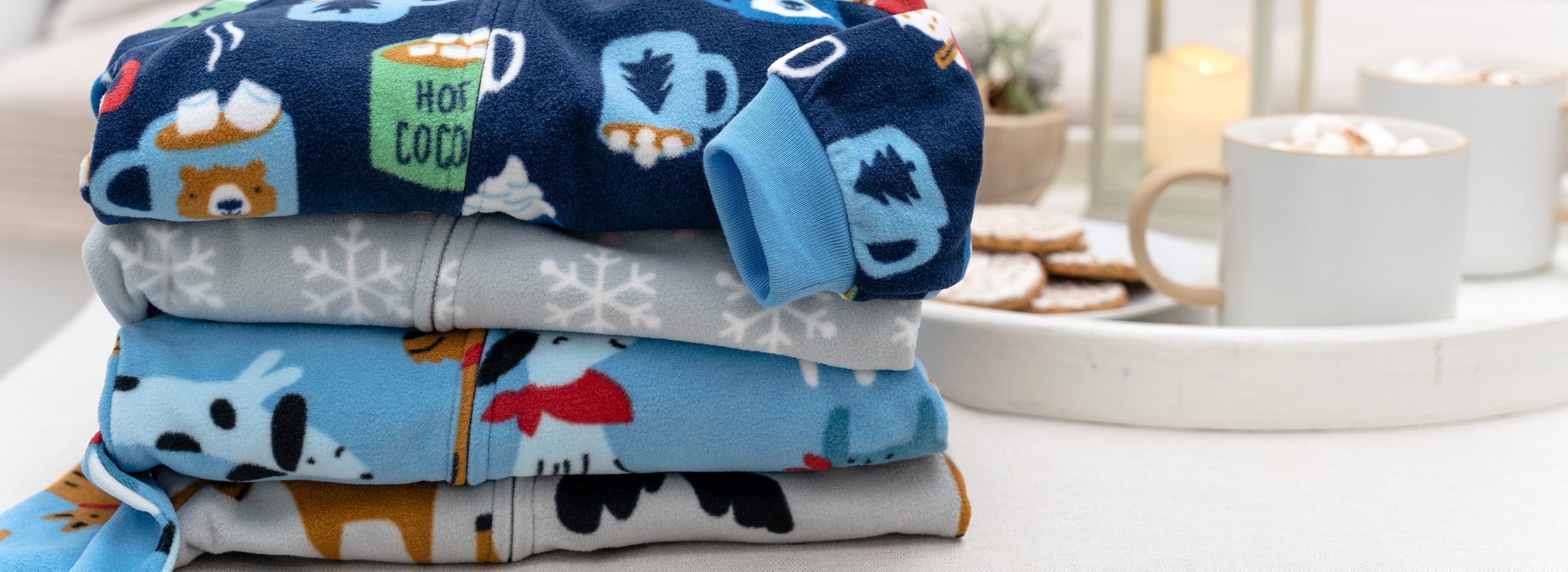 A stack of pajamas featuring adorable dogs and cats. Perfect for a cozy night's sleep.