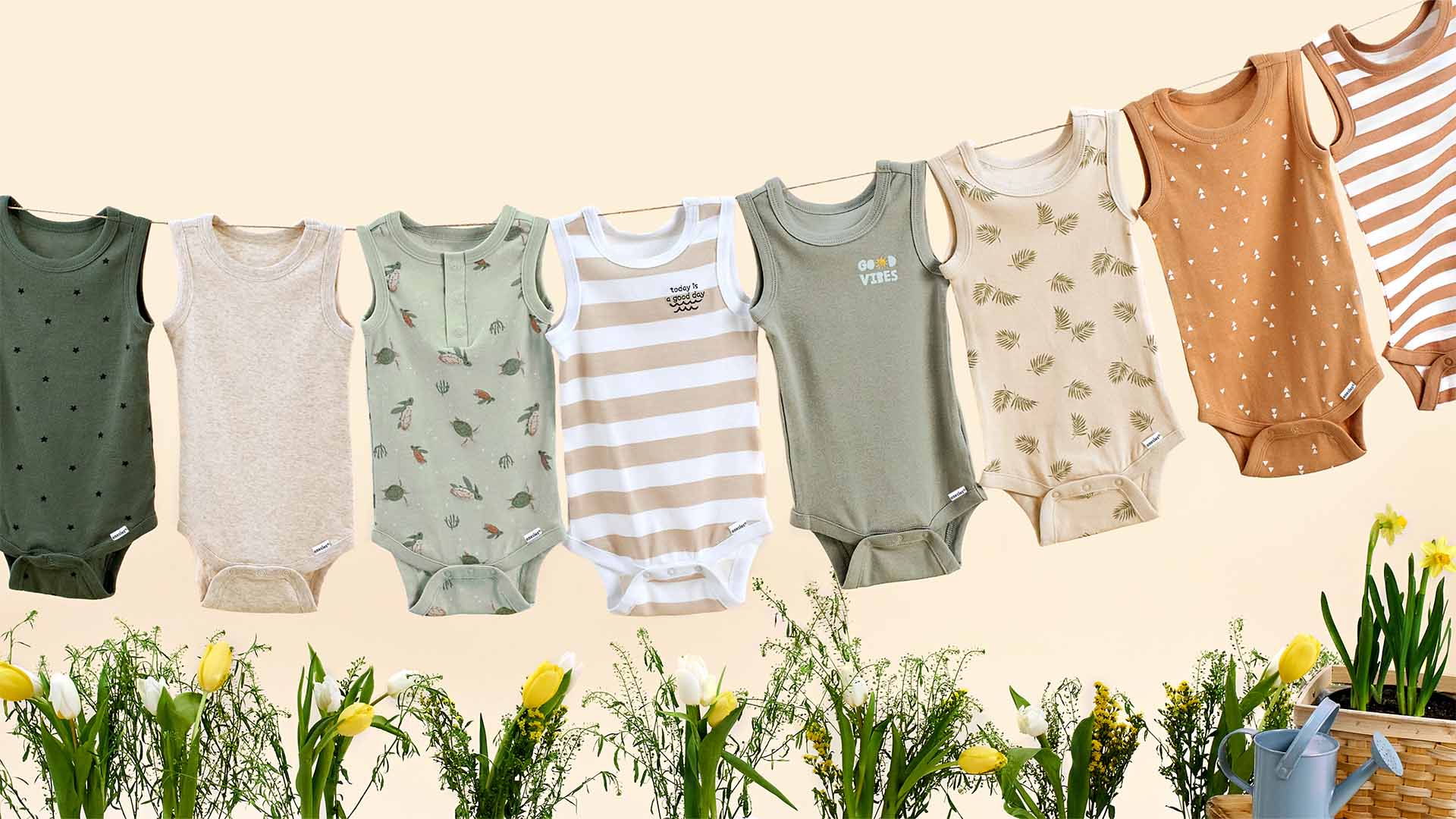 Spring colored baby boy bodysuits hanging on a clothesline,