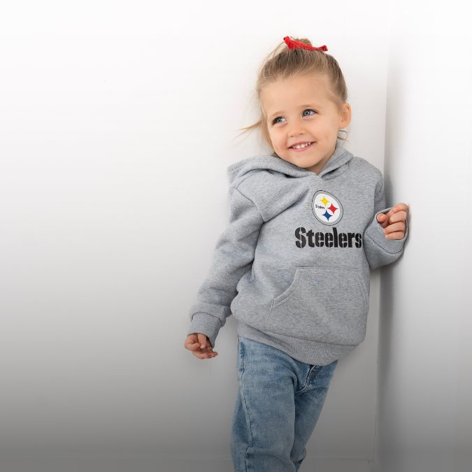 A toddler girl wearing a Pittsburgh Steelers hoodie.