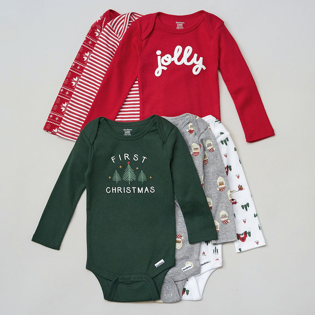 Collection of Christmas-themed baby clothing including red, green, and gray onesies on a light gray background.