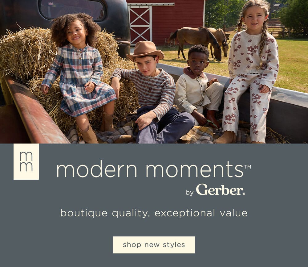 Children sitting on a truck bed with a red barn and horses in the background, featuring the 'modern moments by Gerber' logo.