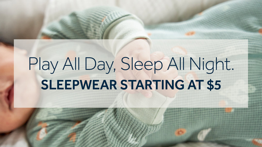 Play all day, sleep all night. Sleepwear starting at $5. In the background is a baby in pajamas.