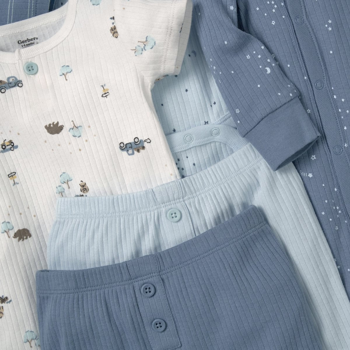 Children's clothing set with patterned shirt, pants, and cardigan on a white background