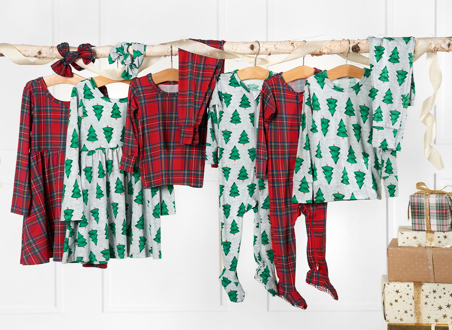 Colorful Christmas pajamas for toddlers and babies, arranged on a clothesline.