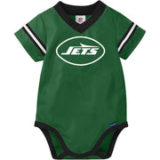 Green baby onesie with 'Jets' logo on a white background