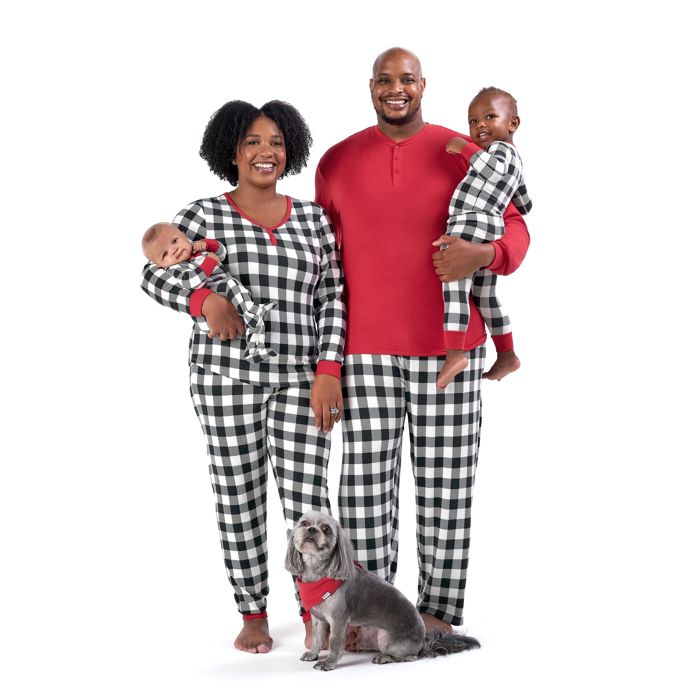 The image depicts a family wearing red and black plaid pajamas along with their pet dog.