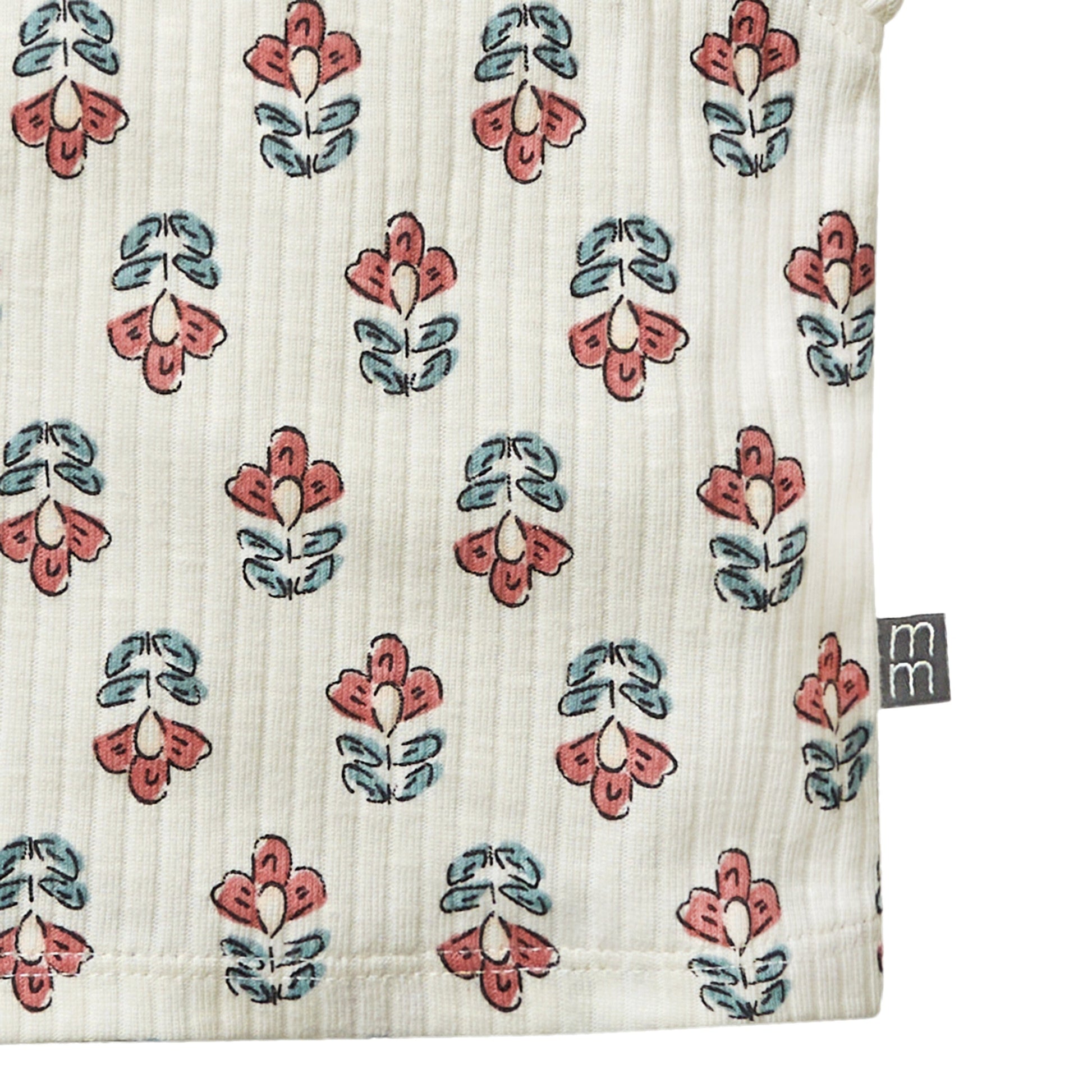 Textile with floral pattern and 'm' brand logo on a white background
