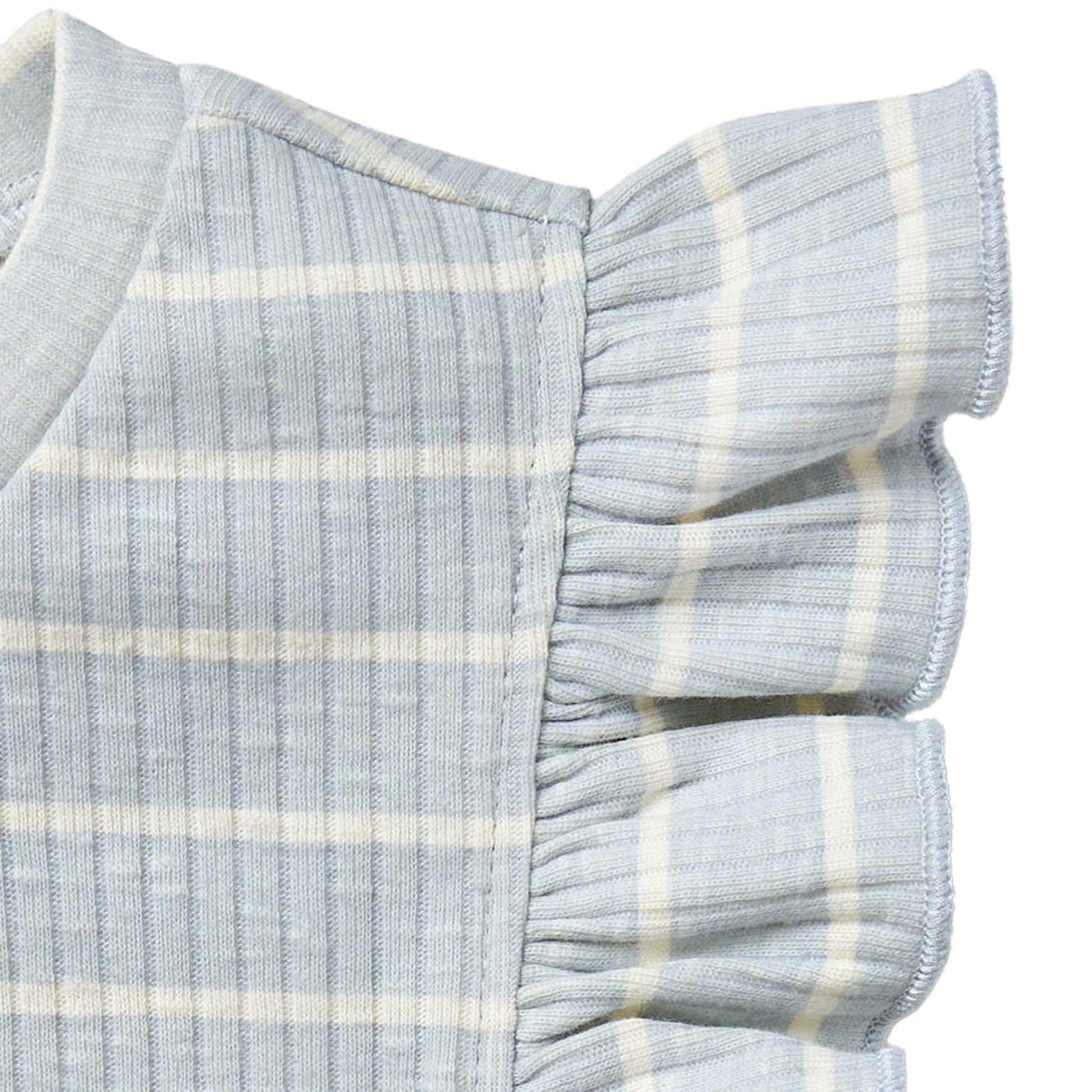 Close-up of a light blue and white striped fabric with ruffled edges on a white background