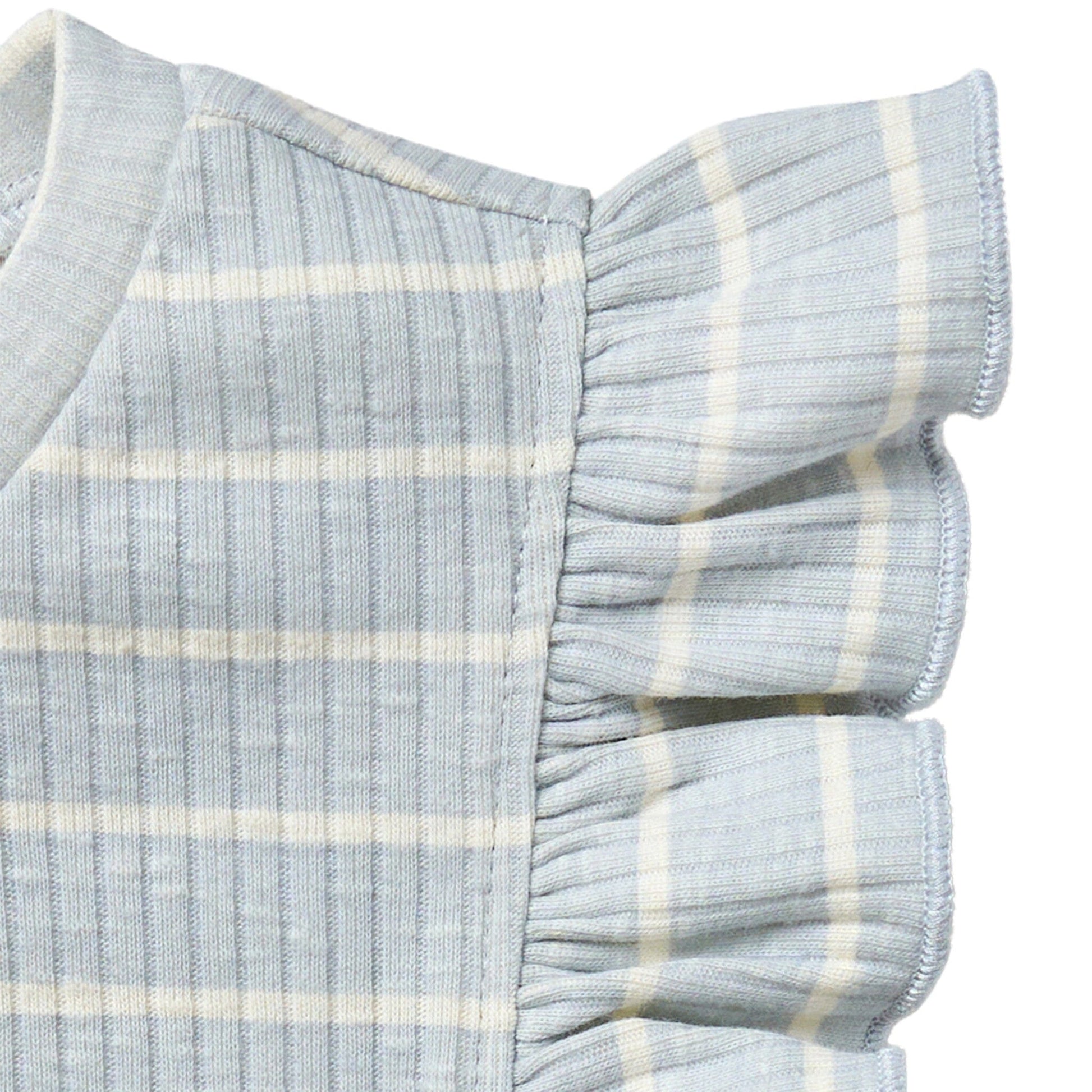 Close-up of a baby outfit with ruffled sleeves on a white background
