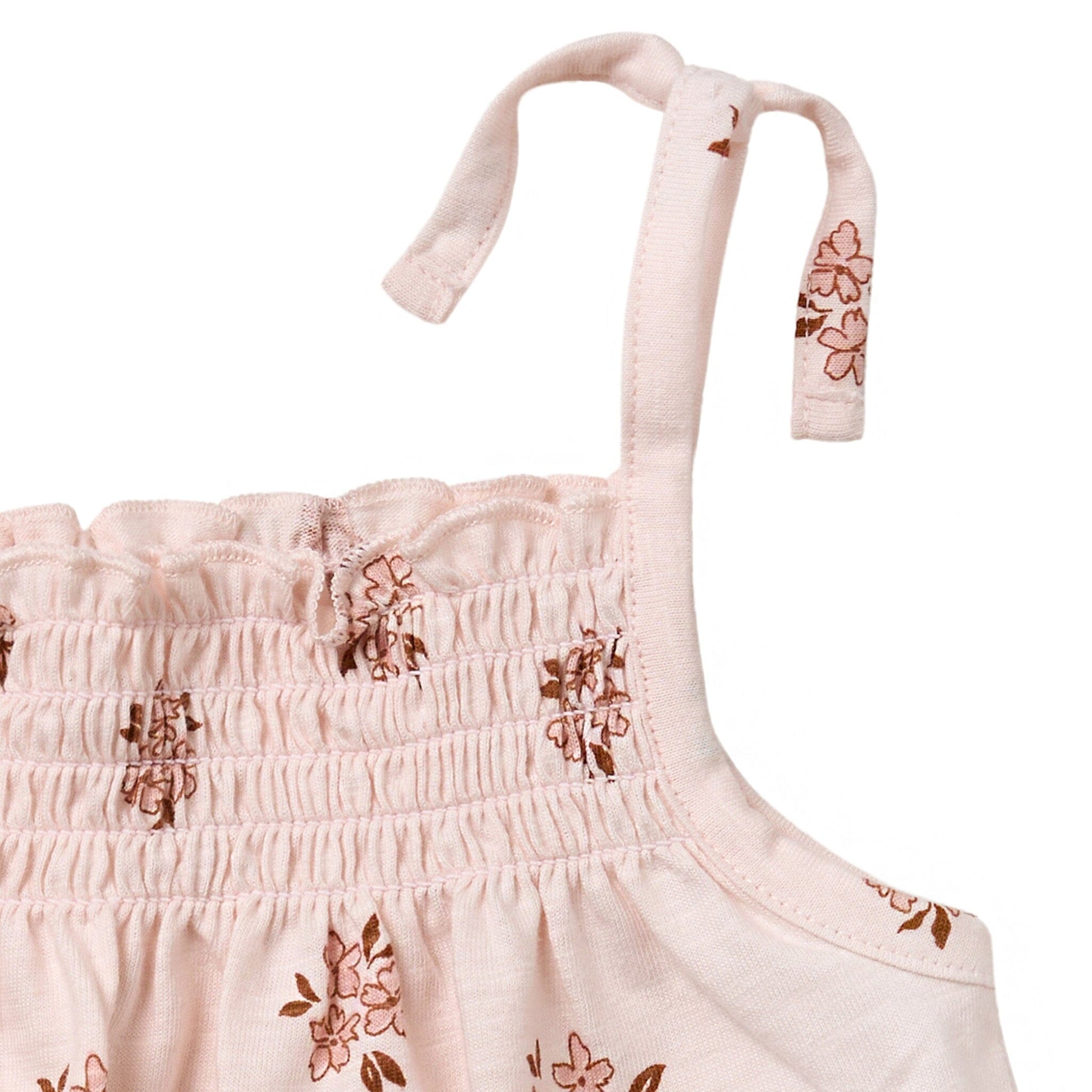 Pink floral dress with straps on a white background