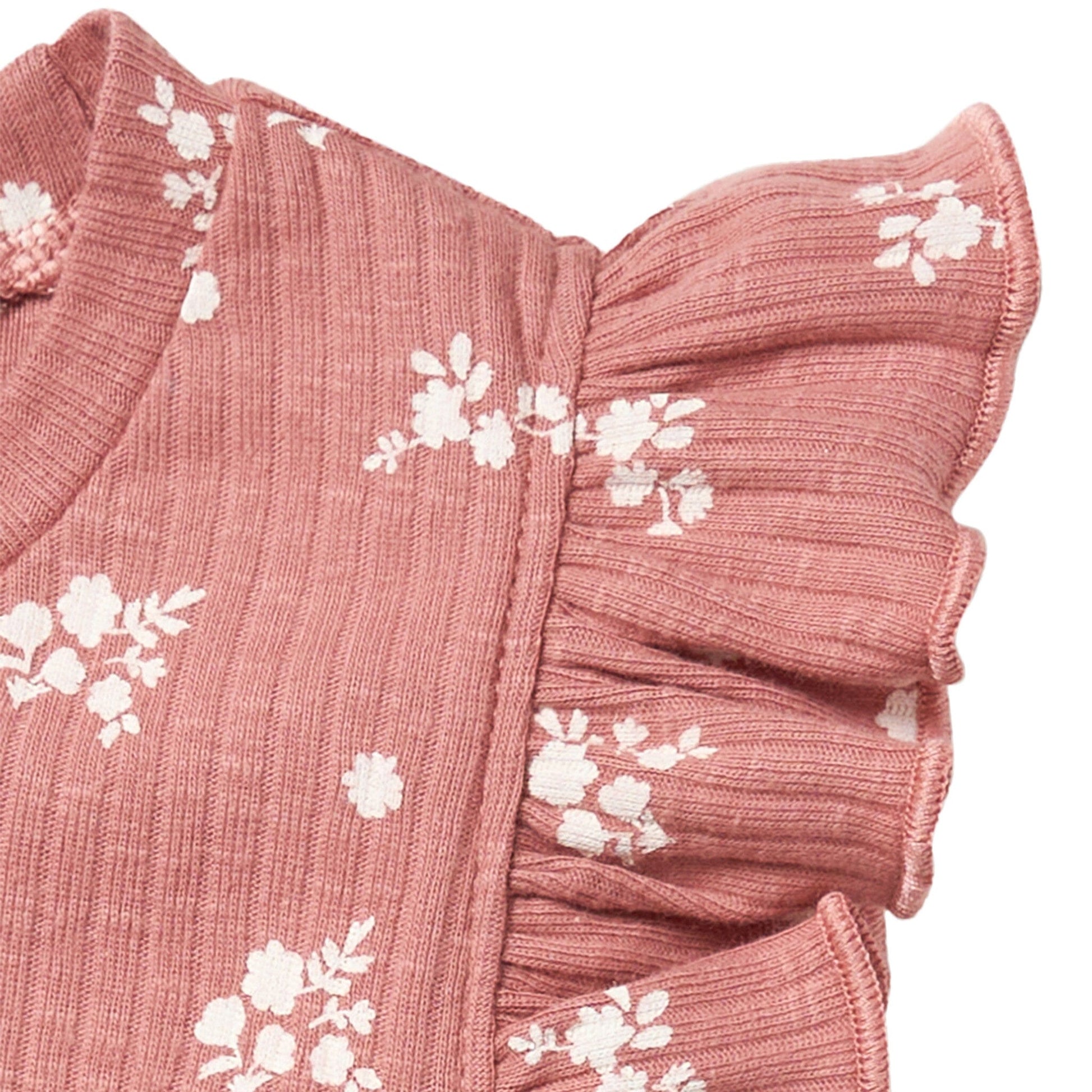 Pink fabric with white floral patterns on a white background
