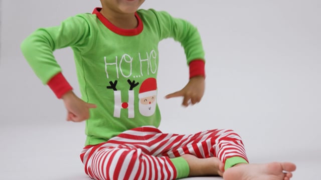 Cute babies dancing in Gerber Christmas 2-Pack baby neutral reindeer & snowflake snug fit footed cotton pajamas. 